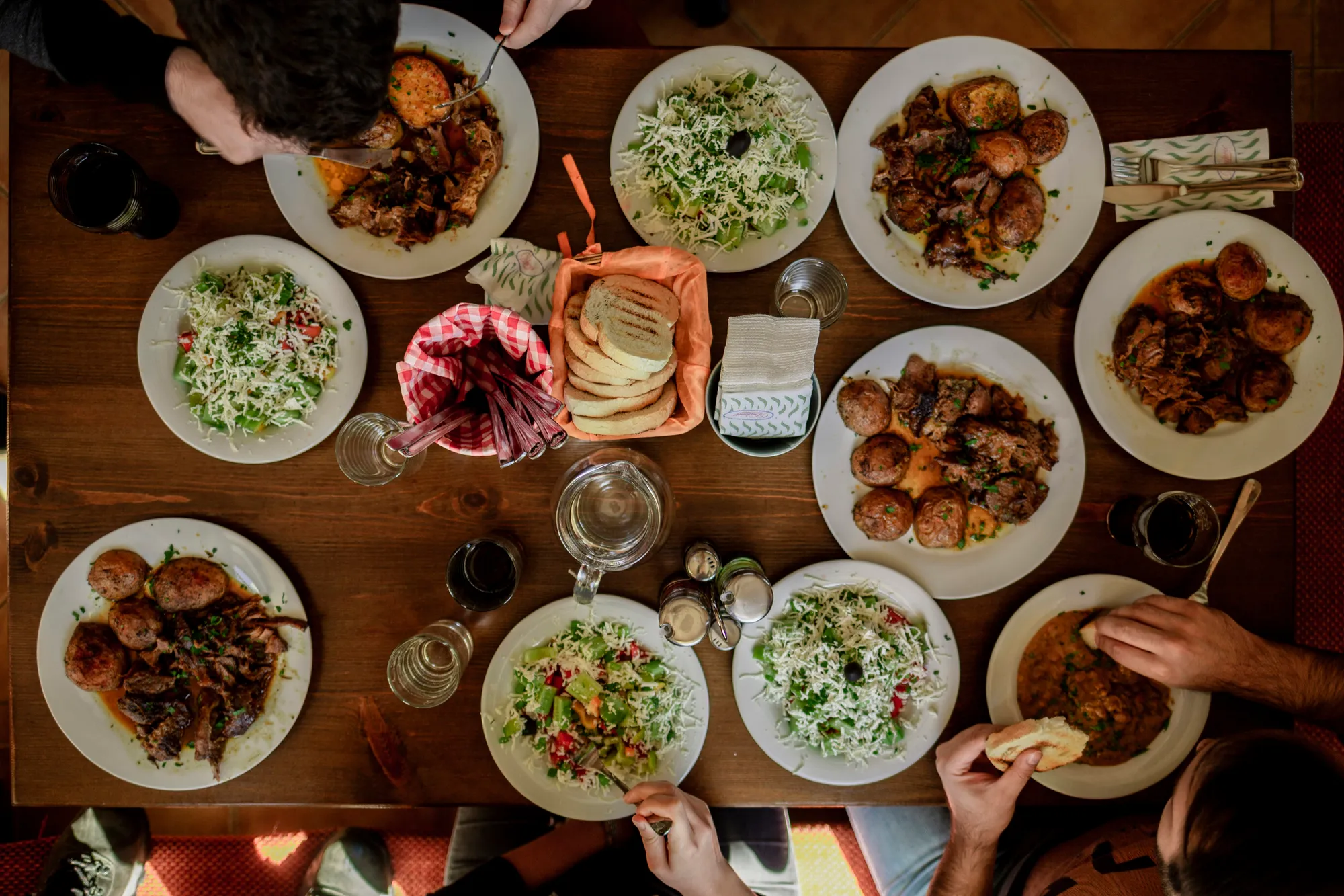 An overhead table set with many shared dishes